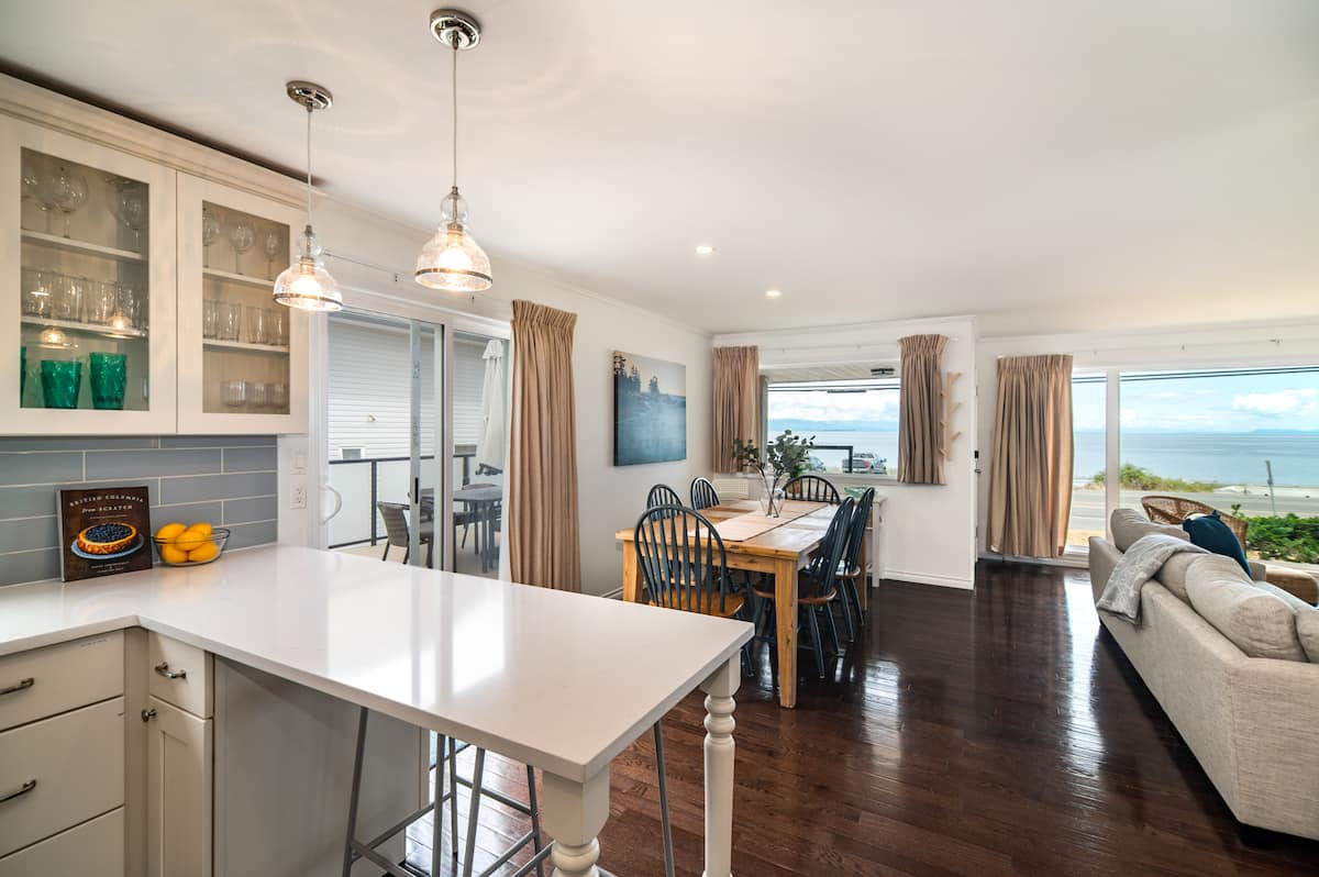 Open-plan living area with panoramic ocean views at Stories Beach House
